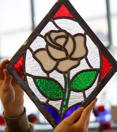 Stained glass image of a white rose