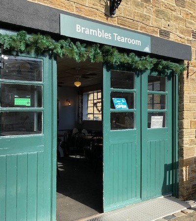 A set of green doors which open into Brambles Tearoom
