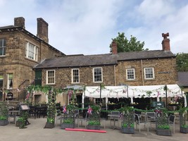 Elsecar Heritage Centre - Front entrance to The Pantry cafe with a white awning and planters