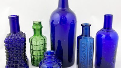 Glass bottles of different styles in blue and green colours
