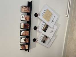 Postcards with historic photographs of Elsecar on a shelf above information sheets