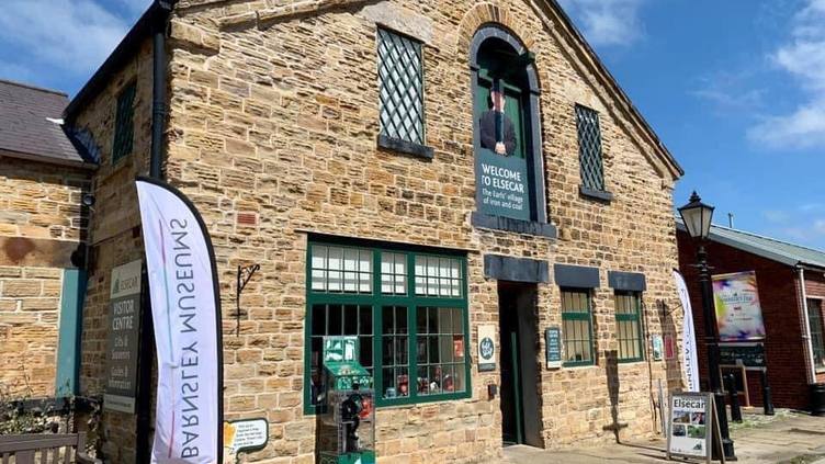 Exterior of Elsecar Visitor Centre - a stone building with green windows and doors