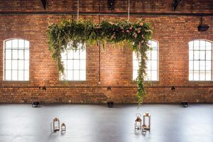 Close up of foliage arch with lantern candles under it