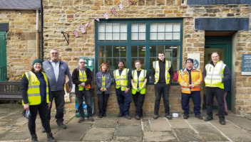 A group of volunteers stood in front of the Visitor Centre at Elsecar Heritage Centre.