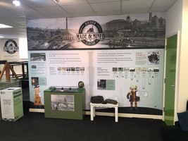 Made and mines display with a timeline of Elsecar heritage centre and some example coal to handle