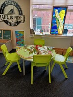 A green table with hands on activities for children