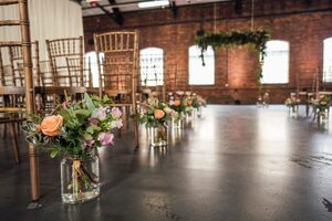 Flowers in jars put next to chairs