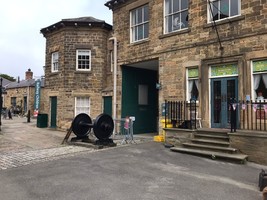 Entrance to the Earl's railway station, a stone hexagonal building. Next to it a door leading out of the heritage centre.