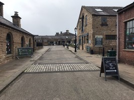 A main street along the heritage centre with the visitor centre on the right and other craft shops along it