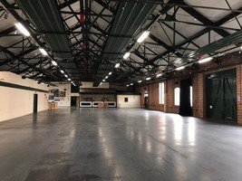 Interior of the ironworks. A large bare room with mechanisms for hanging things from the ceiling. This is used for events.